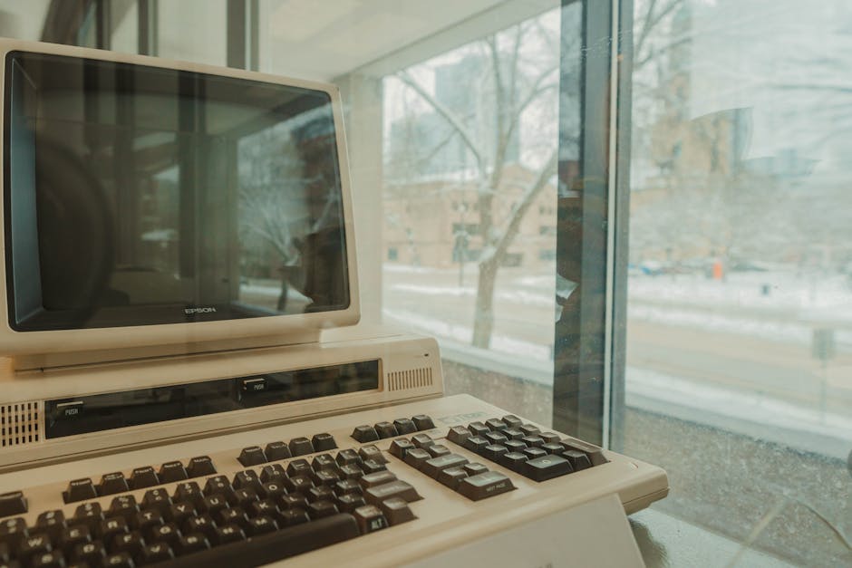 A vintage Epson computer displayed indoors against a snowy window view in Milwaukee during winter.